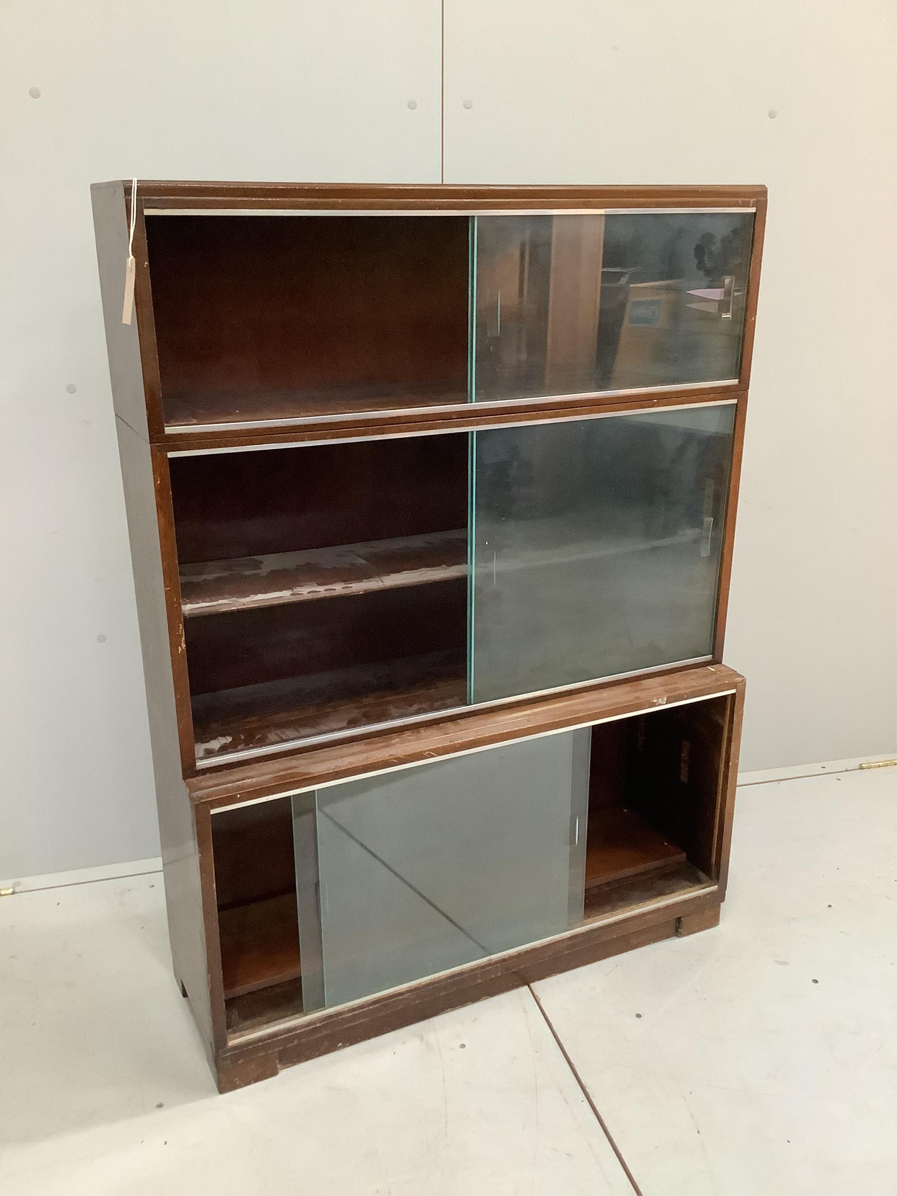 A mid century Minty style mahogany three section bookcase, width 89cm, depth 29cm, height 121cm. Condition - fair